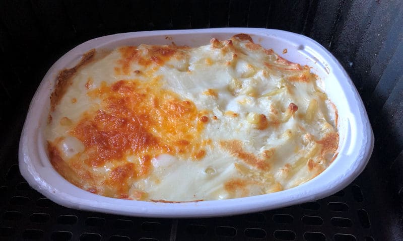 Fully cooked Mac and Cheese ready meal tray sat in air fryer